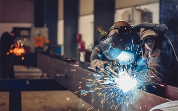 Welder fabricating structural steel components